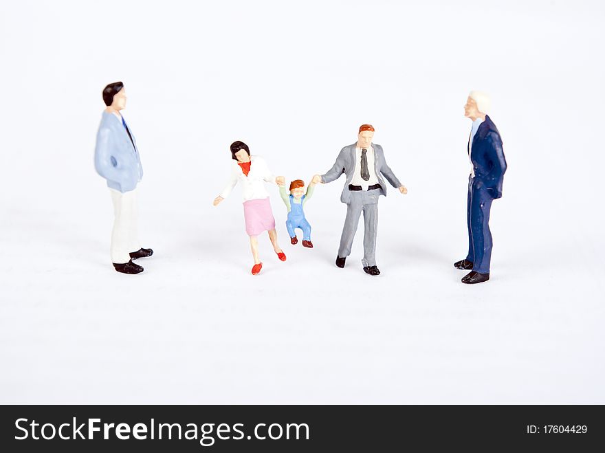 Miniature people with family on white