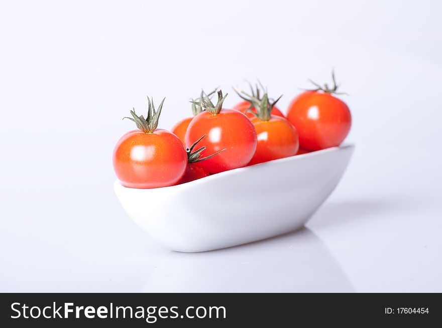 Fresh tomato in white dish with clean lighting. Fresh tomato in white dish with clean lighting