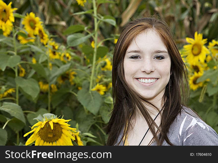 Teenage Girl In A Field Of Sunflowers