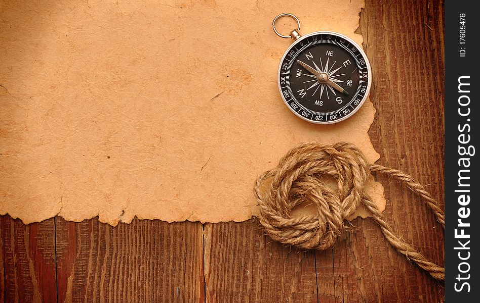 Compass and rope on grunge paper background. Compass and rope on grunge paper background