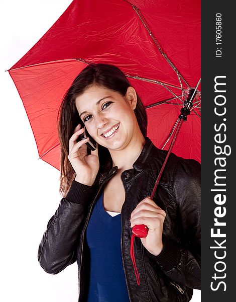 A young woman is smiling while talking on the phone and holding an umbrella. A young woman is smiling while talking on the phone and holding an umbrella.