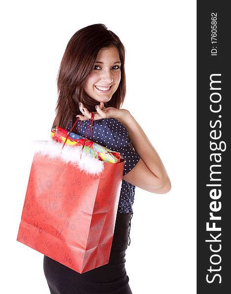 A young woman is smiling while looking over her shoulder holding a bag. A young woman is smiling while looking over her shoulder holding a bag.