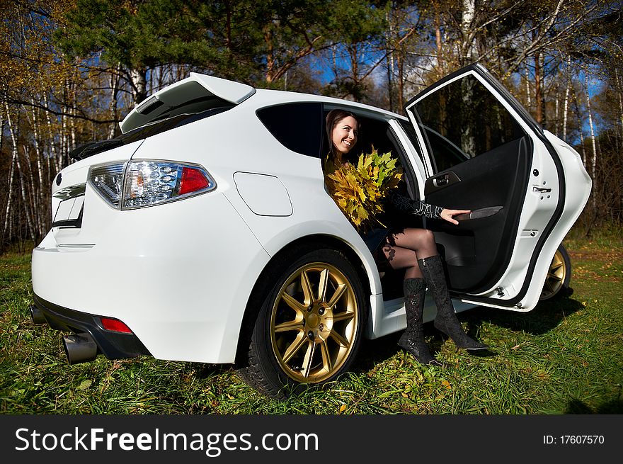 Happy Girl With Yellow Leaves In White Stylish Car