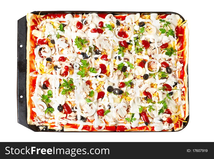 Pizza in baking tray waiting for oven. Isolated on white.