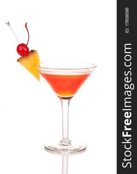 Red Cosmopolitan cocktail with vodka, rum, triple sec, red cranberry and lemon juice, pineapple, maraschino cherry in martini glass isolated on a white background. Red Cosmopolitan cocktail with vodka, rum, triple sec, red cranberry and lemon juice, pineapple, maraschino cherry in martini glass isolated on a white background