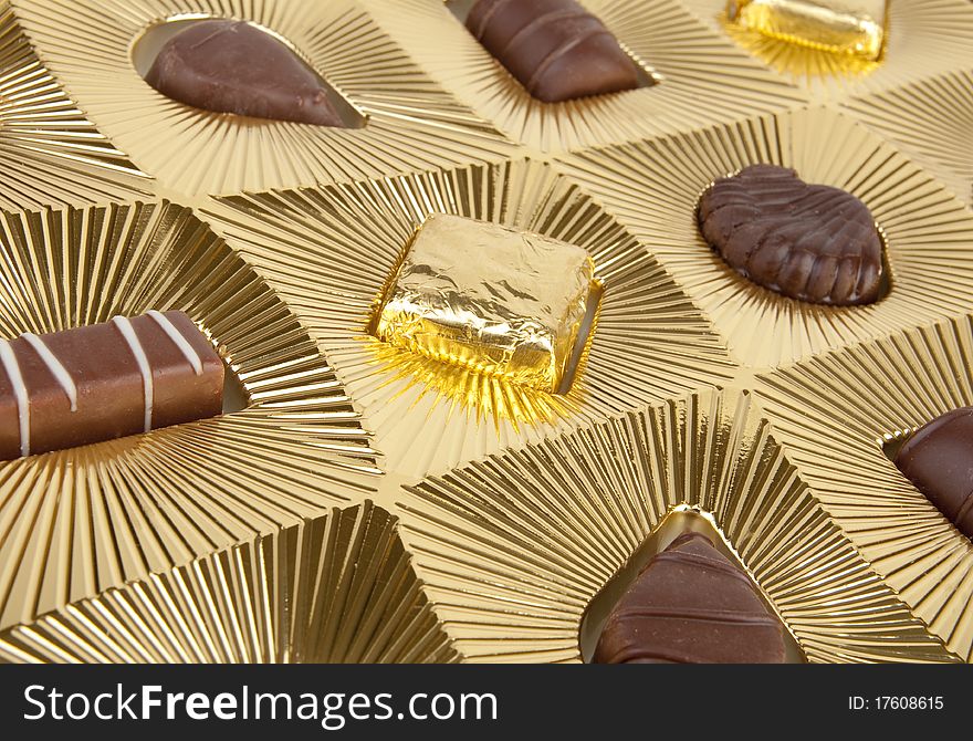 Box of chocolates with gold background