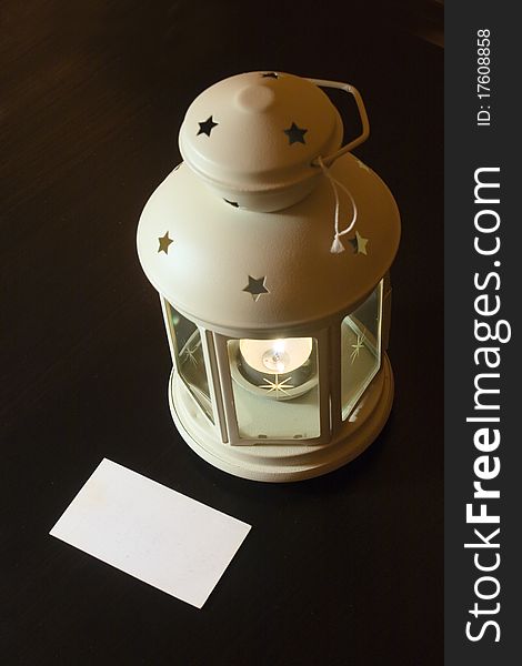 Blank visiting card and a candlestick  on black table