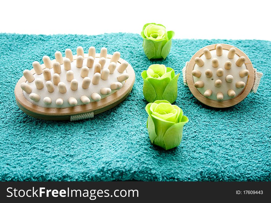 Massage brush and flower blossom on towel