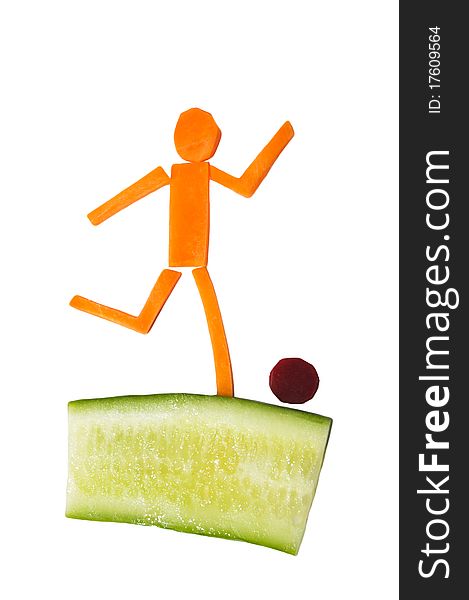 Man made of carrots and cucumber playing football