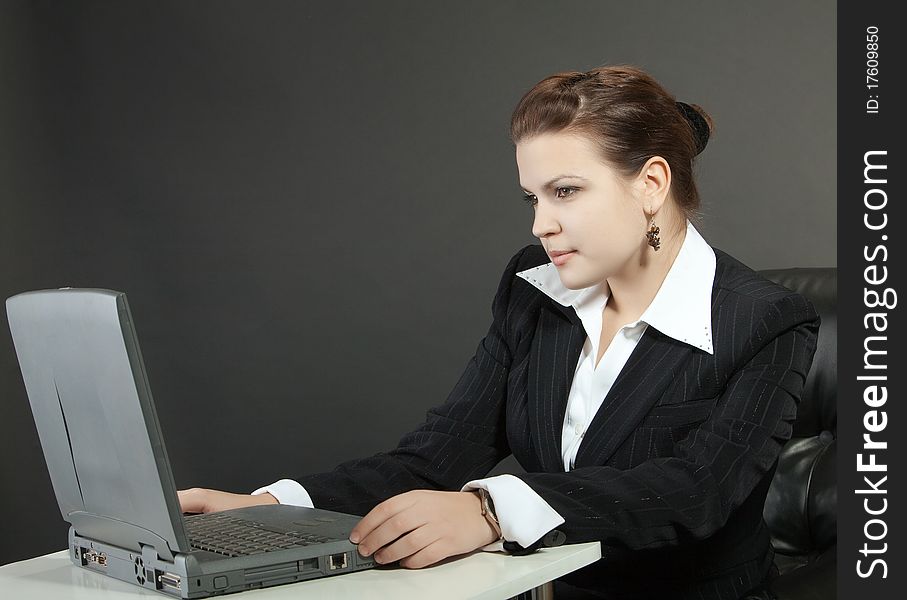 Young woman works on a computer in a office. Young woman works on a computer in a office