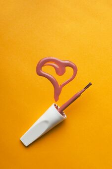 Vertical Shot.Top View Of Brush For Nail Art And Heart Shape Made Of Spilled Nail Polish Stock Photos