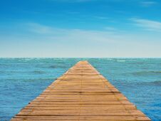 Scenery Of Wooden Walkway, Blue Sea, Cloudy Skies Royalty Free Stock Photography