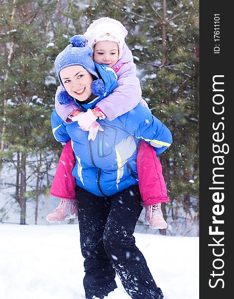 Happy mother and daughter in a winter park