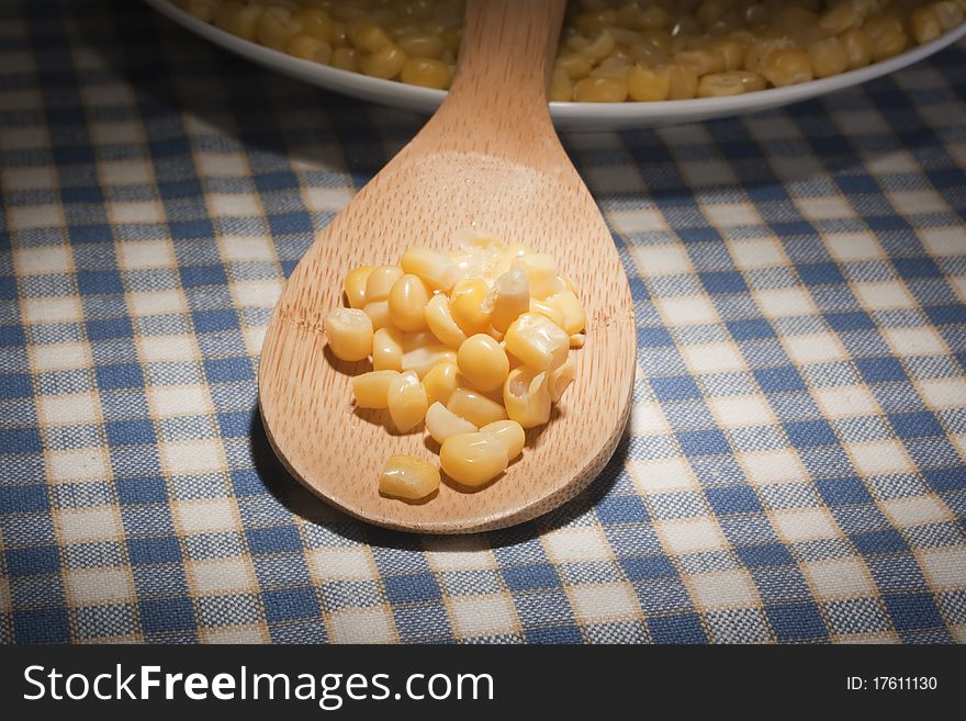 Canned corn in a wooden spoon chef.