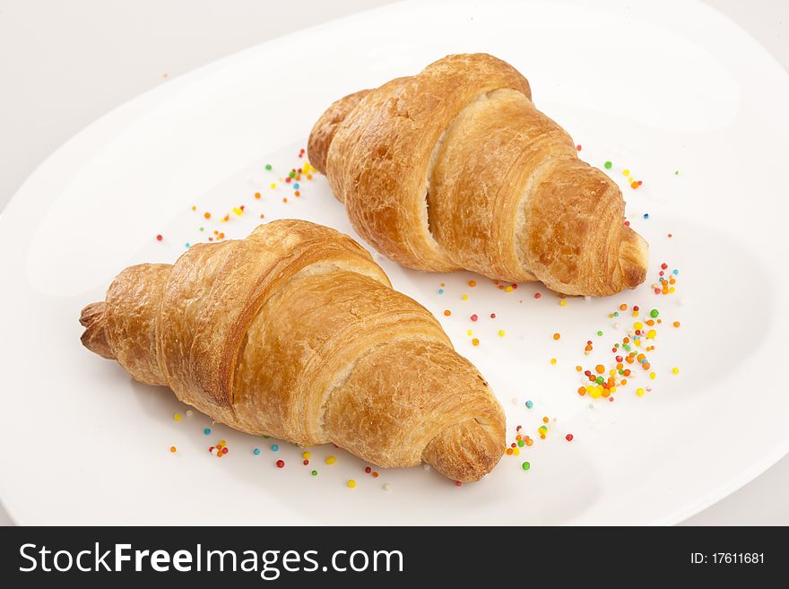 Food series: two tasty fresh croissant on glassy plate