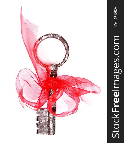 Vintage key and red ribbon isolated on white. Vintage key and red ribbon isolated on white