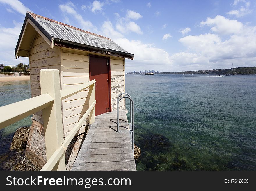 A small shed sits on the edge of a beautiful bay in Australia. A small shed sits on the edge of a beautiful bay in Australia.