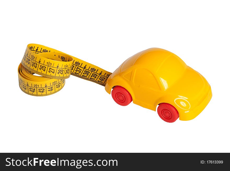 Toy car and a ruler-tape on a white background. Concept. Toy car and a ruler-tape on a white background. Concept