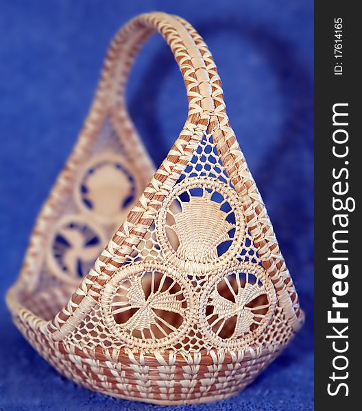 A natural handwoven ethnic basket with intricate designs. A natural handwoven ethnic basket with intricate designs.
