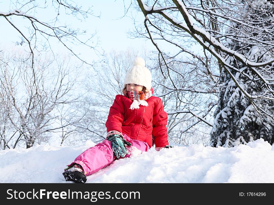 The girl sitting in the snow. Fun in the snow. The girl sitting in the snow. Fun in the snow