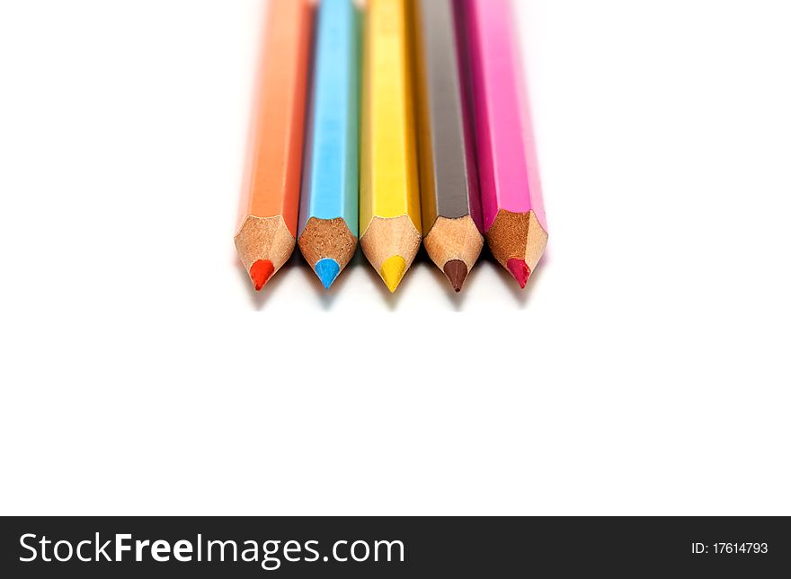 Five colored pencils on a white background