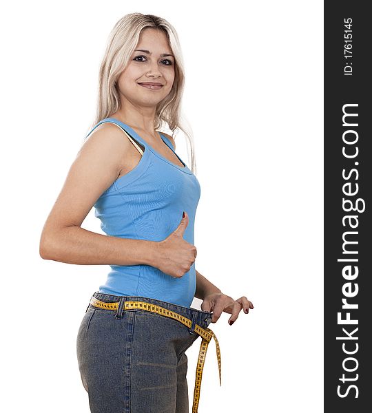 Young happy woman measuring her waist over white background. Young happy woman measuring her waist over white background