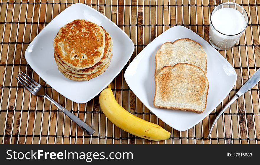 Pancakes, banana and milk for breakfast