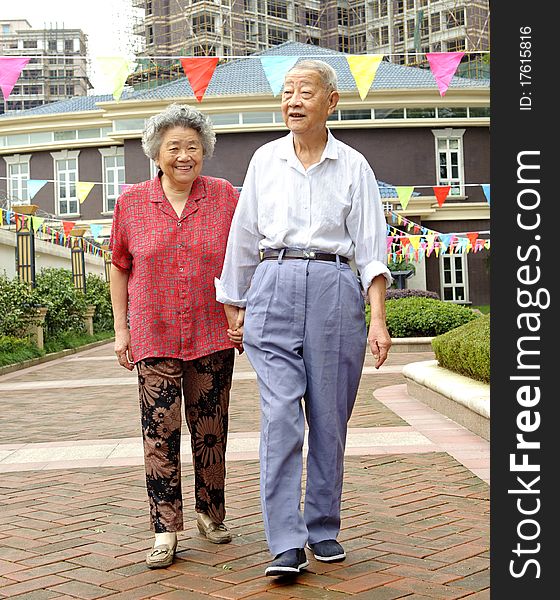 An intimate senior couple are walking. An intimate senior couple are walking