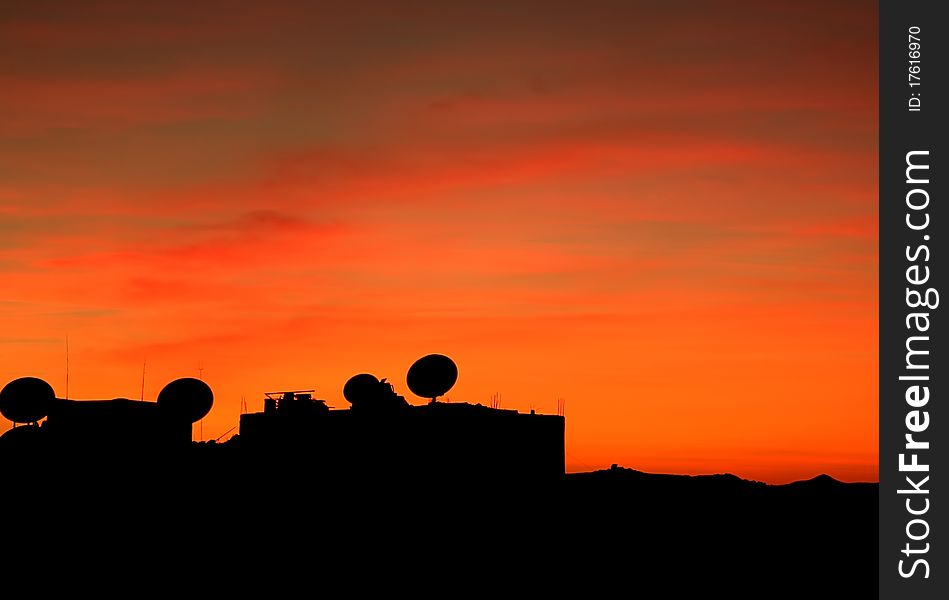 Satellite Dishes silhouetted against the dusk sky. Satellite Dishes silhouetted against the dusk sky.