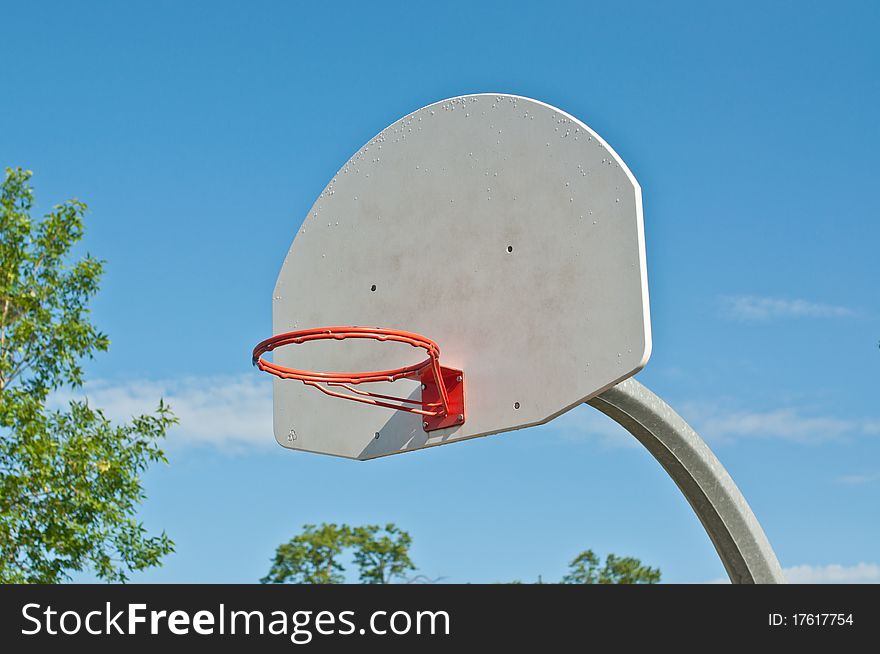 An outdoor basketball hoop in a local park. An outdoor basketball hoop in a local park.