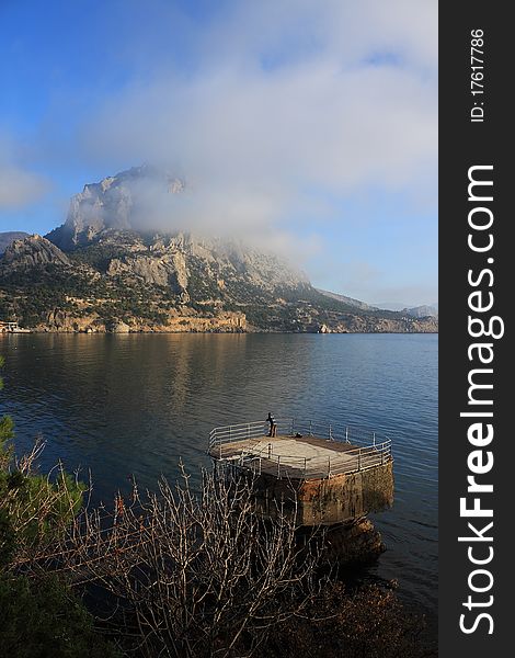 Mountain and sea landscape east of crimea. The mountains and rocks, covered with juniper and pine. Blue sea. Mountain and sea landscape east of crimea. The mountains and rocks, covered with juniper and pine. Blue sea