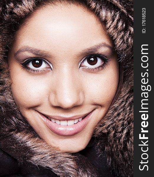Beautiful Winter Woman smiling in a fur hat. Beautiful Winter Woman smiling in a fur hat