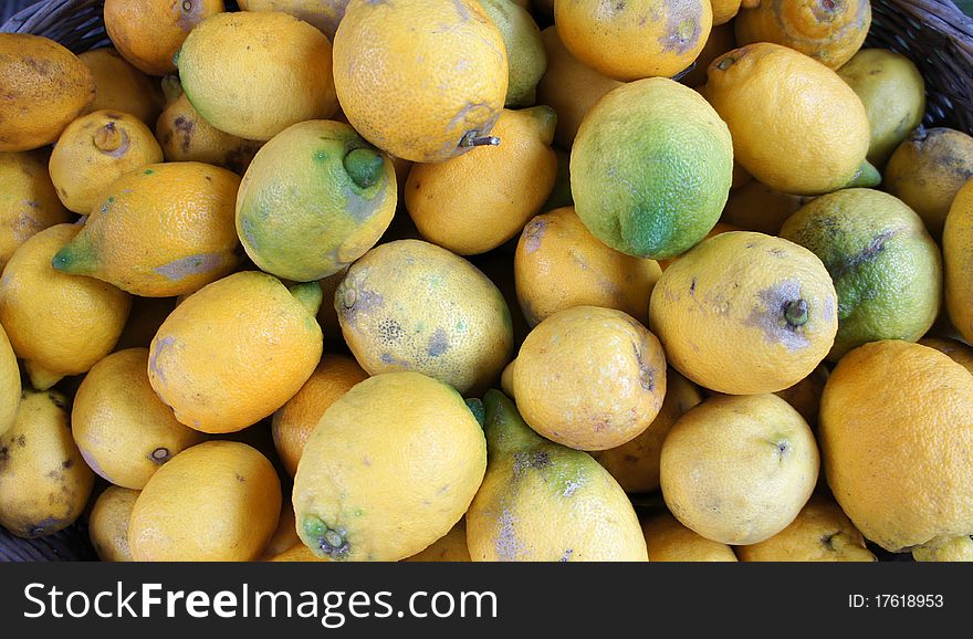 Green and yellow lemons at market place