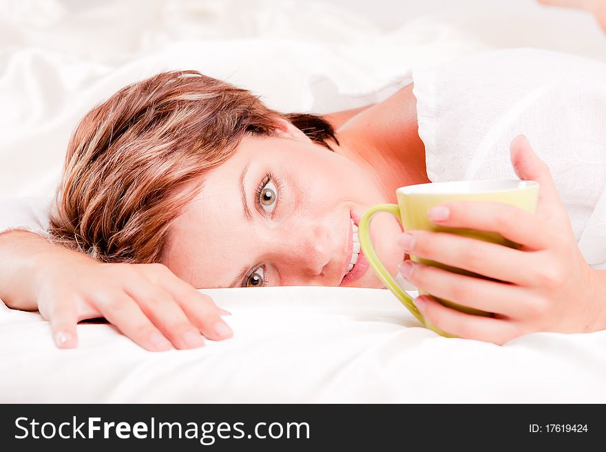 Beatiful woman having breakfast in white bed. Beatiful woman having breakfast in white bed