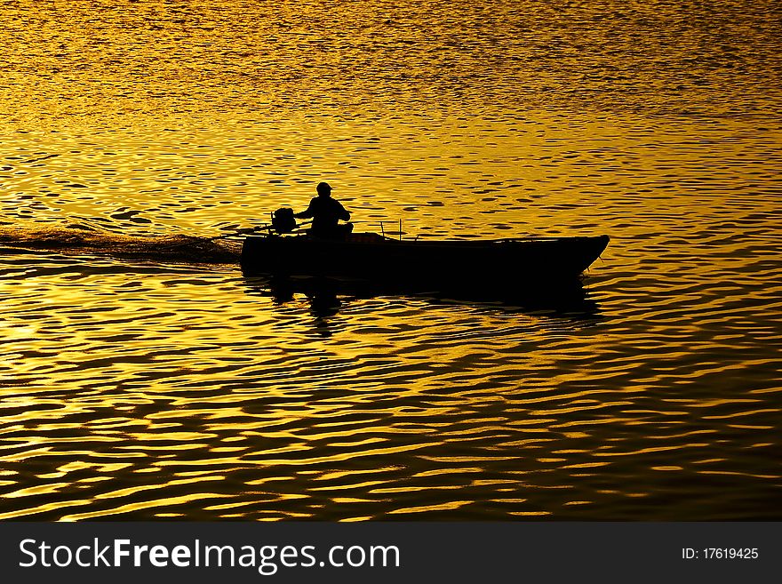 Fisherman boat on the sea during sunset