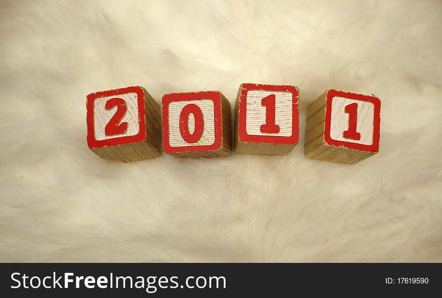 Calendar year 2011 on white fluffy background. Calendar year 2011 on white fluffy background