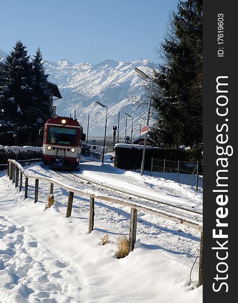 Small regional train in winter panorama of zell am see, austria.