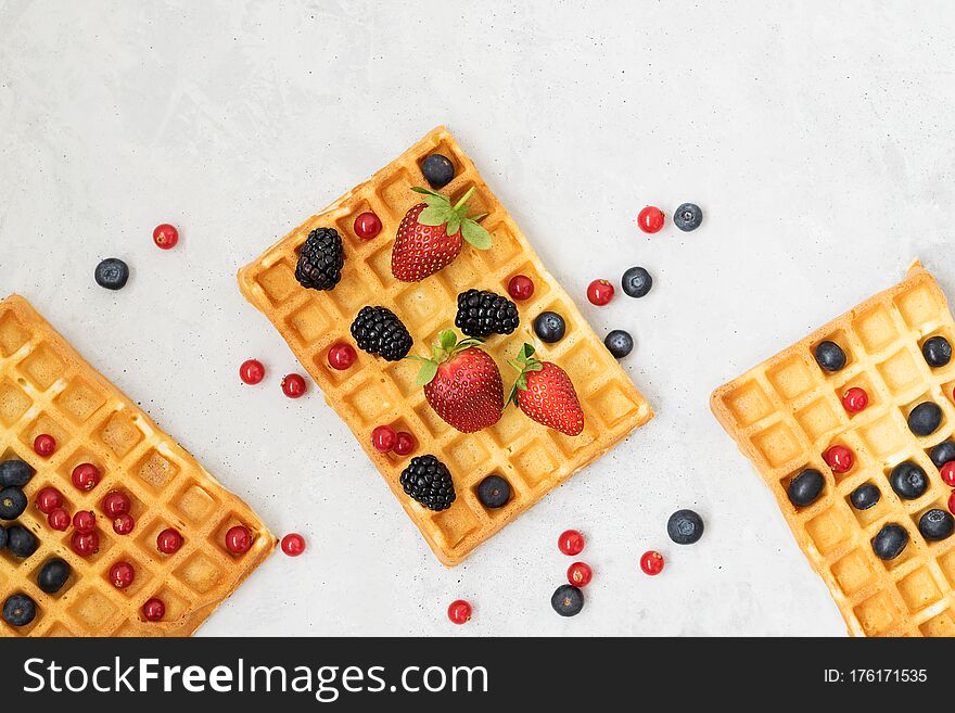 Traditional Belgian Waffles With Berries On A Grey Background