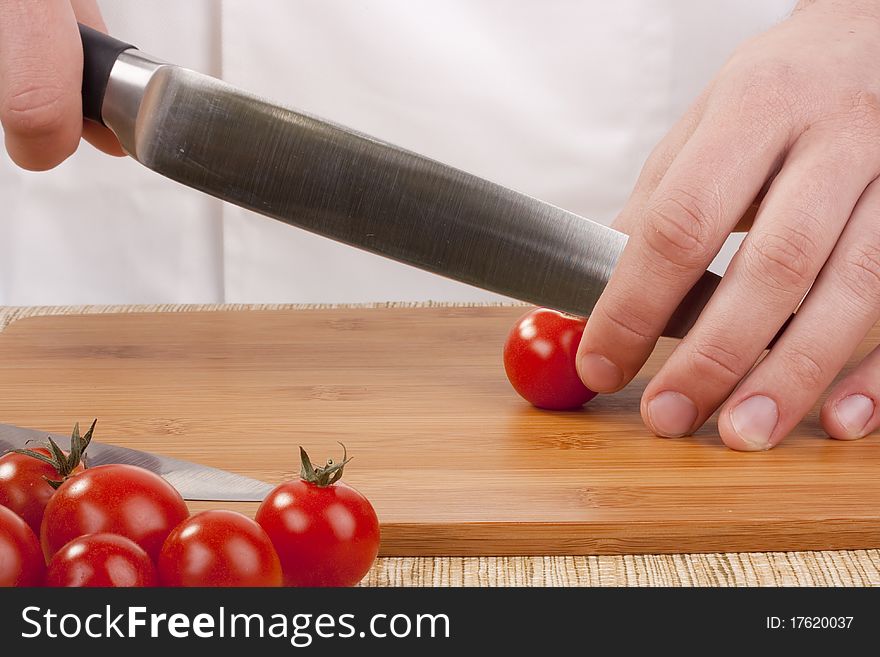 Chef Man cut vegetables on kitchen blackboard.