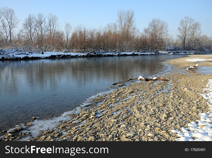 Cold snowy river in winter sunny day. Cold snowy river in winter sunny day