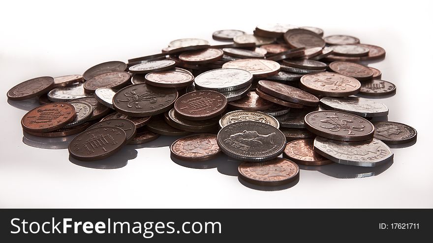 Pile of english coins on white