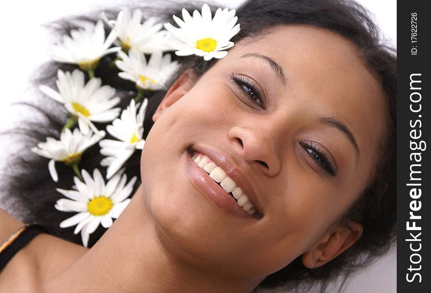 Beautiful young female with daisies in her hair - perfect for spa and wellness concepts. Beautiful young female with daisies in her hair - perfect for spa and wellness concepts.