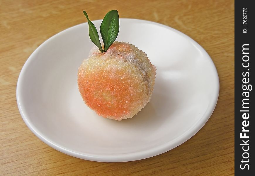 Photo of a peach-shaped sweetie on a plate