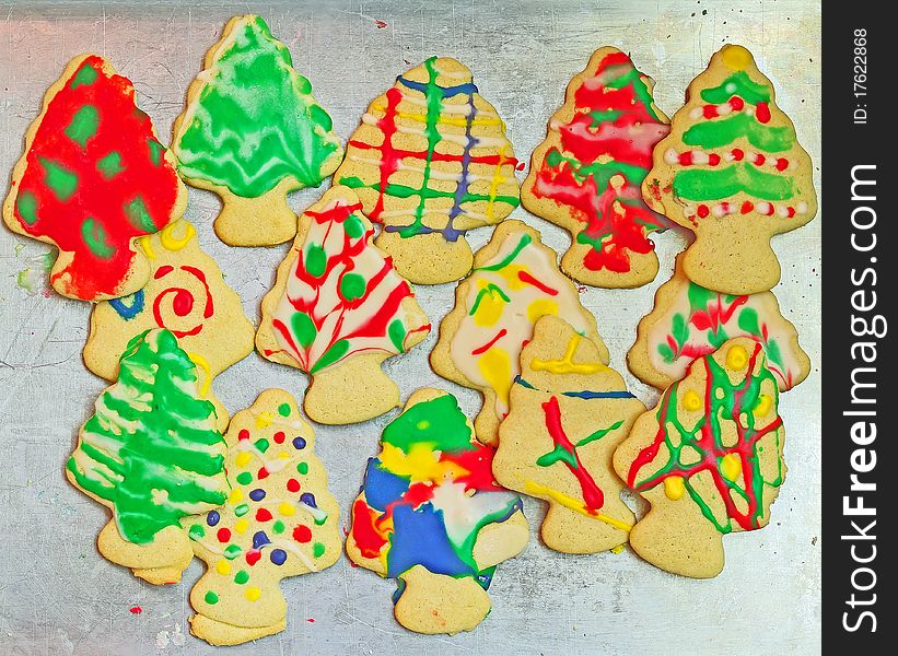 Christmas tree cookies decorated and stacked on a cookie sheet. Christmas tree cookies decorated and stacked on a cookie sheet