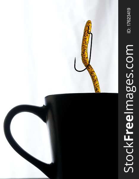 Close up image of coffee cup with fishing lure. Close up image of coffee cup with fishing lure