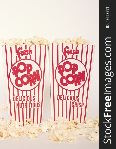 Fresh popcorn in two red and white striped popcorn boxes. Fresh popcorn in two red and white striped popcorn boxes