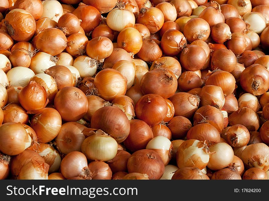 Background of golden onions at the market. Background of golden onions at the market