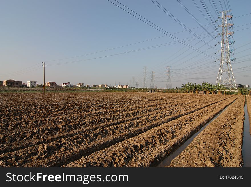 High-voltage tower with farmland