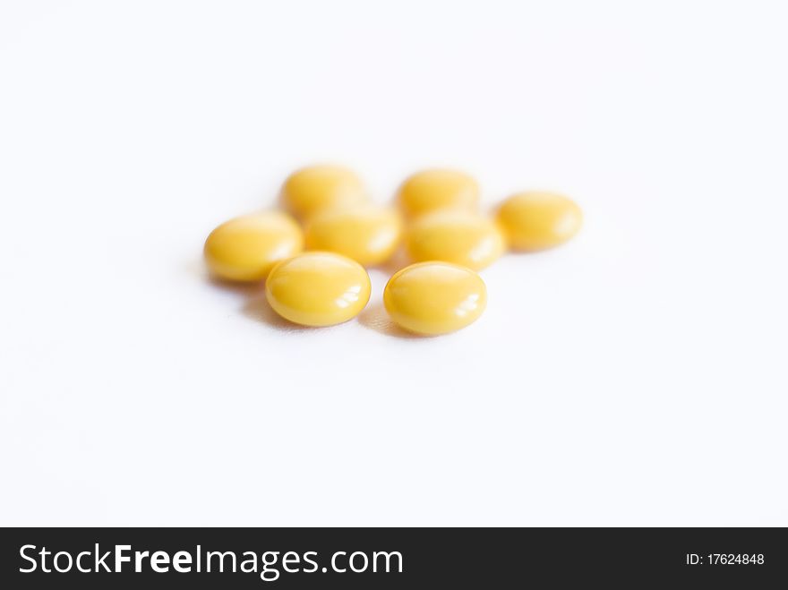 Yellow pills on isolated background