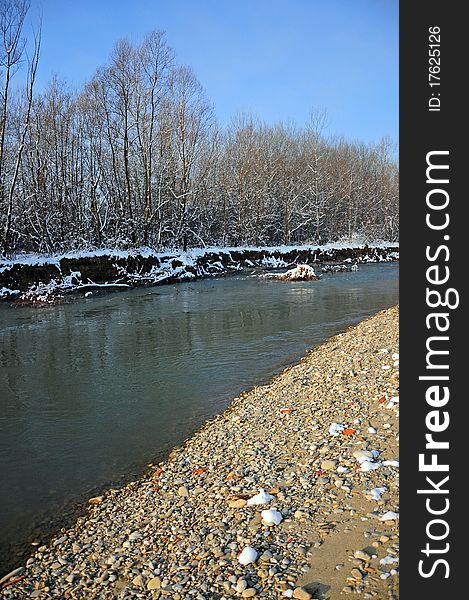 Convergent curves on rocky river in a winter sunny day